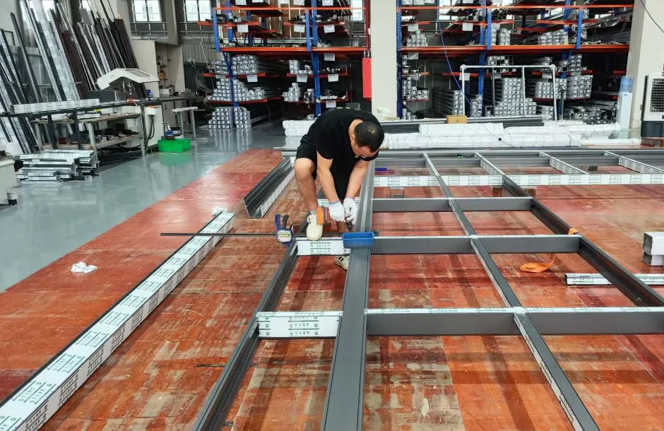 An aluminum frame being assembled on a workbench.